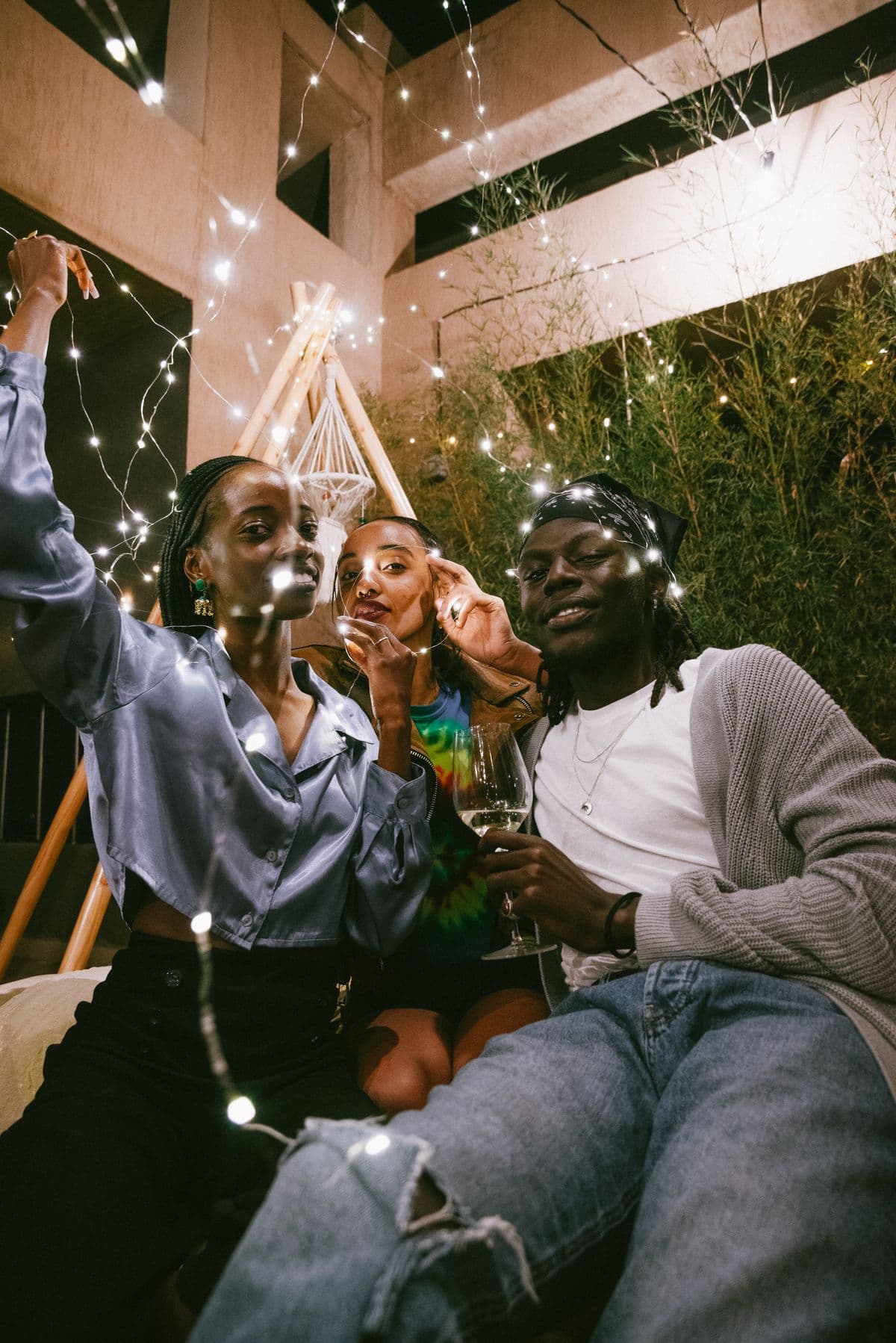Friends celebrating together under string lights